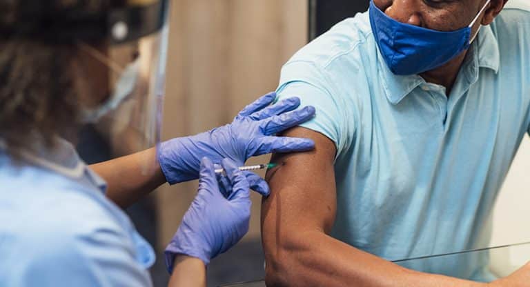 man receiving the COVID-19 vaccine