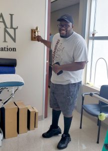 Johnny ringing the bell at the successful end of his treatment