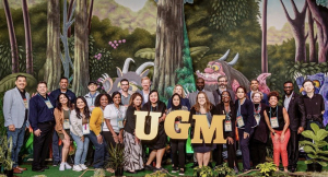 Epic UGM 2024 (Users Group Meeting) conference attendees in front of a jungle-themed background