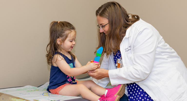 Sarah Cavenaugh, MD, and pediatric patient