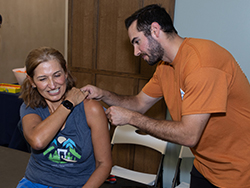 Orthopedics professional applying tape to a marathon participant.