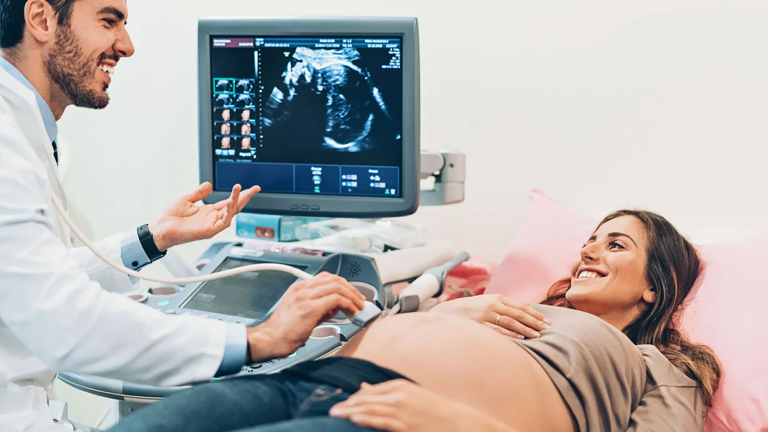 Doctor and a pregnant woman during ultrasound exam in the hospital