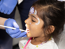 Child receiving a free dental check