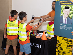 Children receiving free gifts from the environmental health and safety team