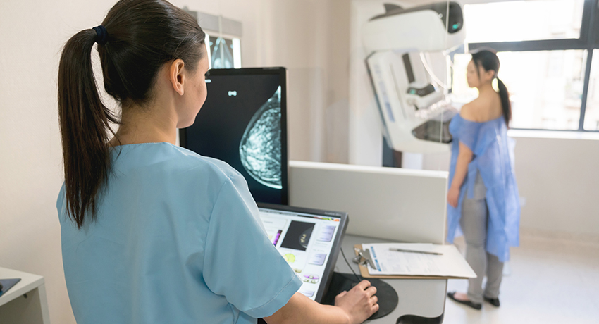 medical professional taking a mammogram exam to an adult patient