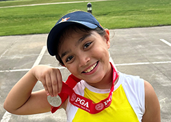 Ariella posing with her champion's medal