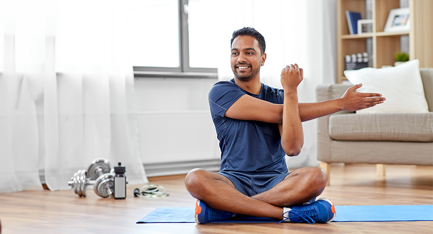 Adult male performing stretching exercises